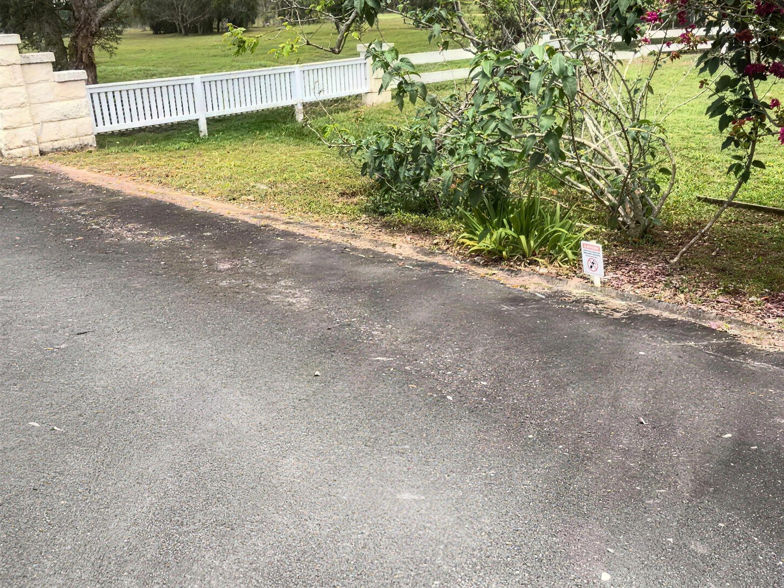 Untidy garden bed by the driveway before the job