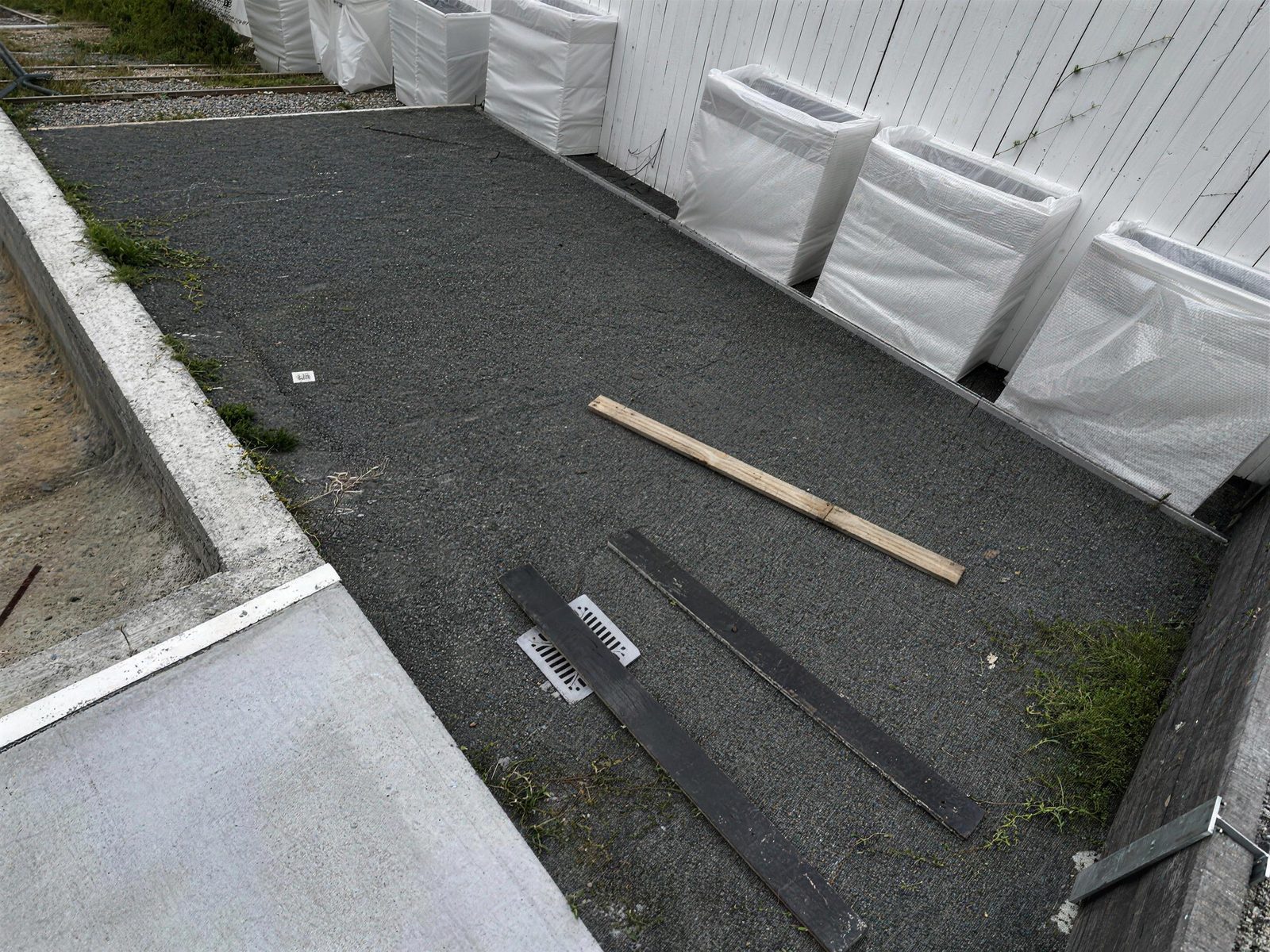 Bare gravel courtyard before the makeover