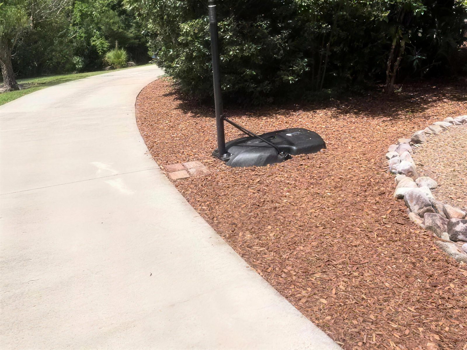 Fresh mulched garden bed beside the driveway
