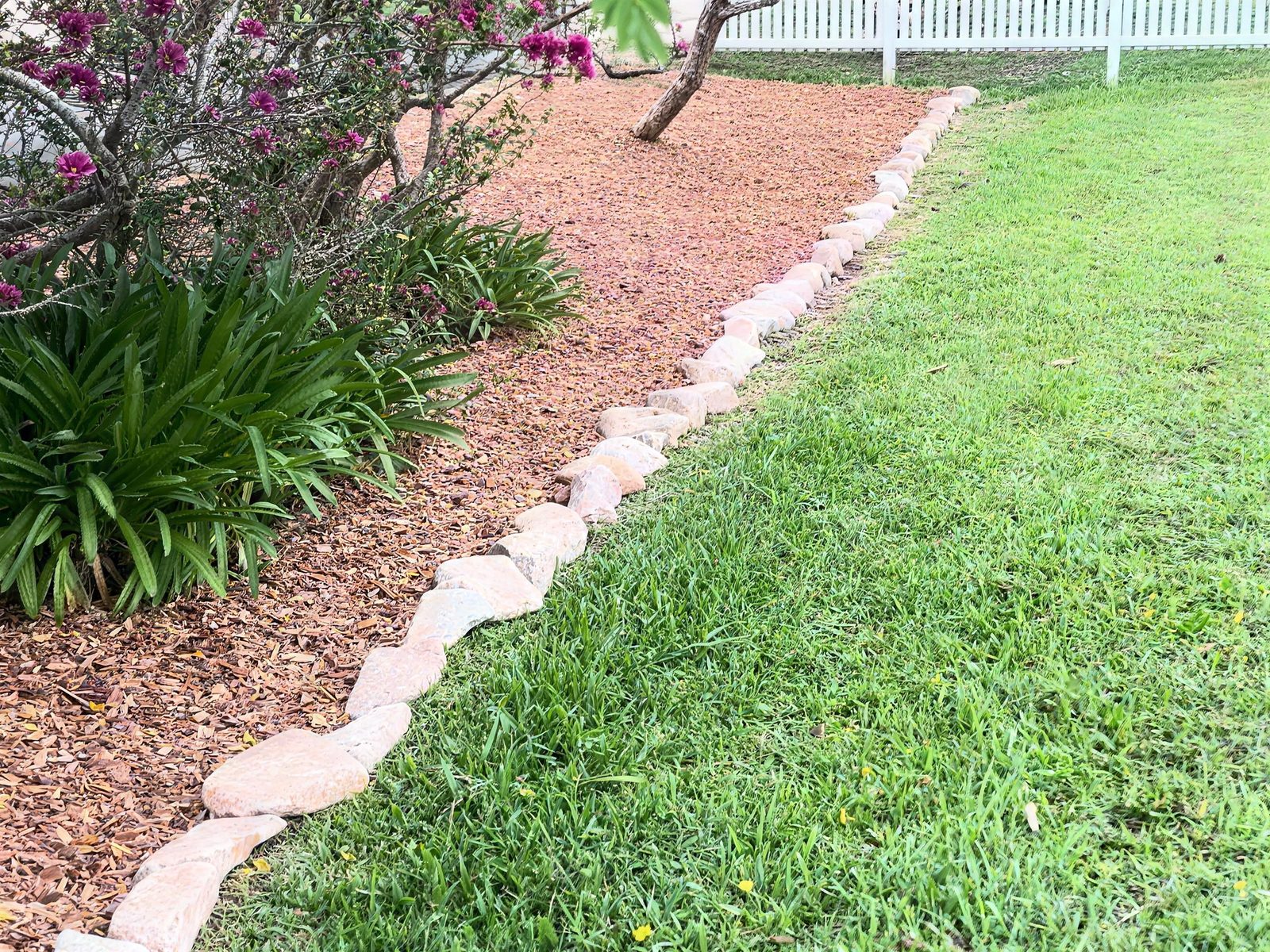 Garden bed with fresh mulch and rock edging