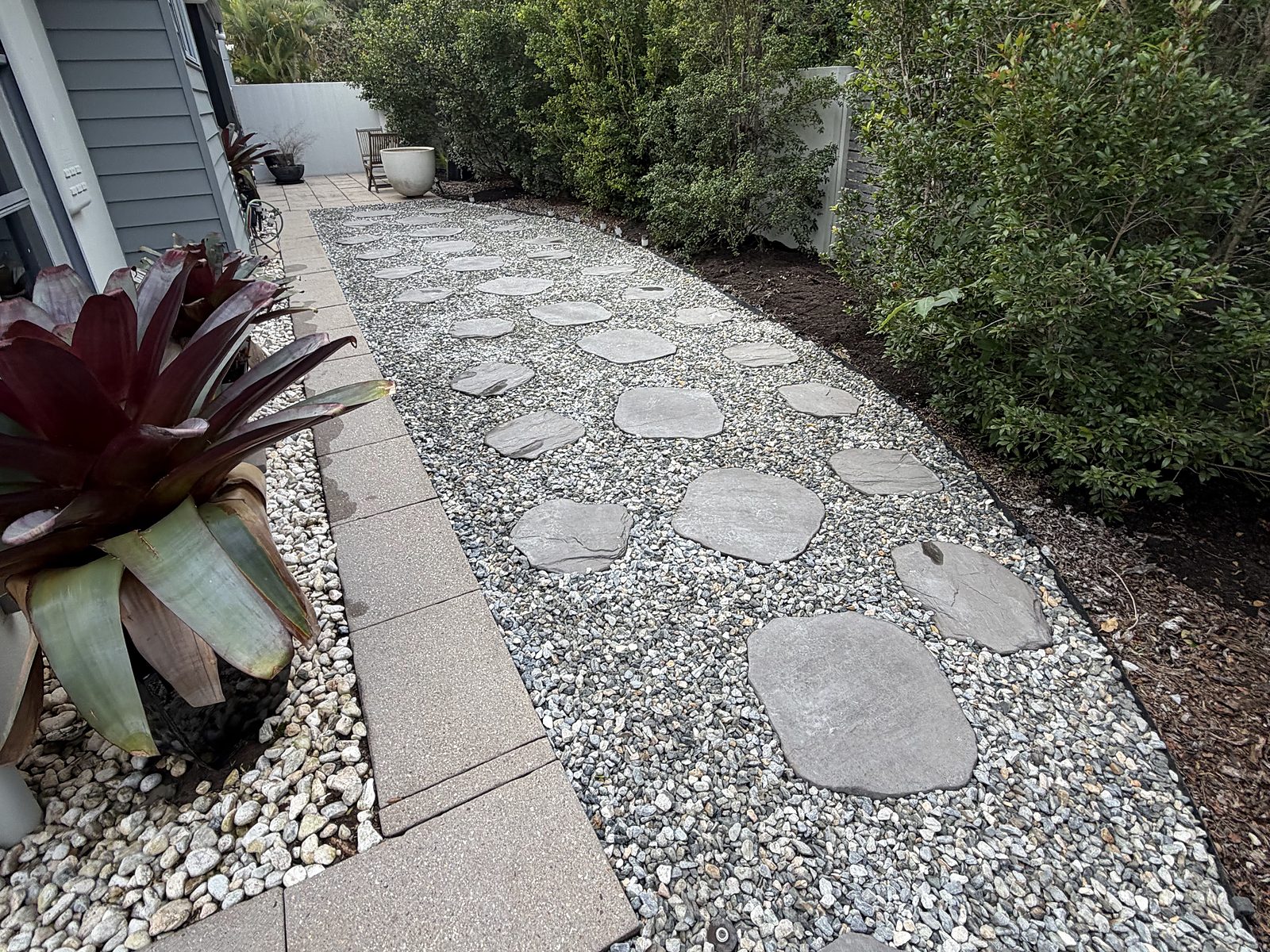 Pebble path with stepping stones beside the house