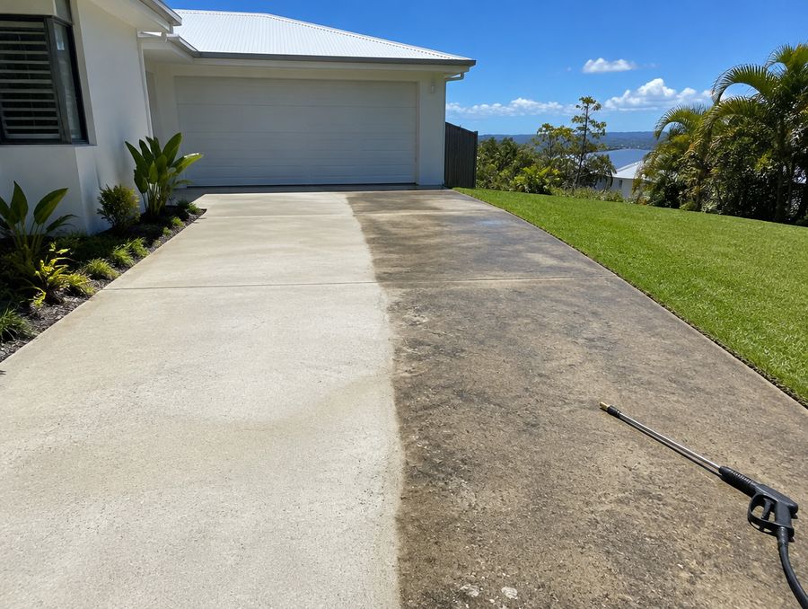 Driveway half pressure washed, showing clean and dirty concrete side by side
